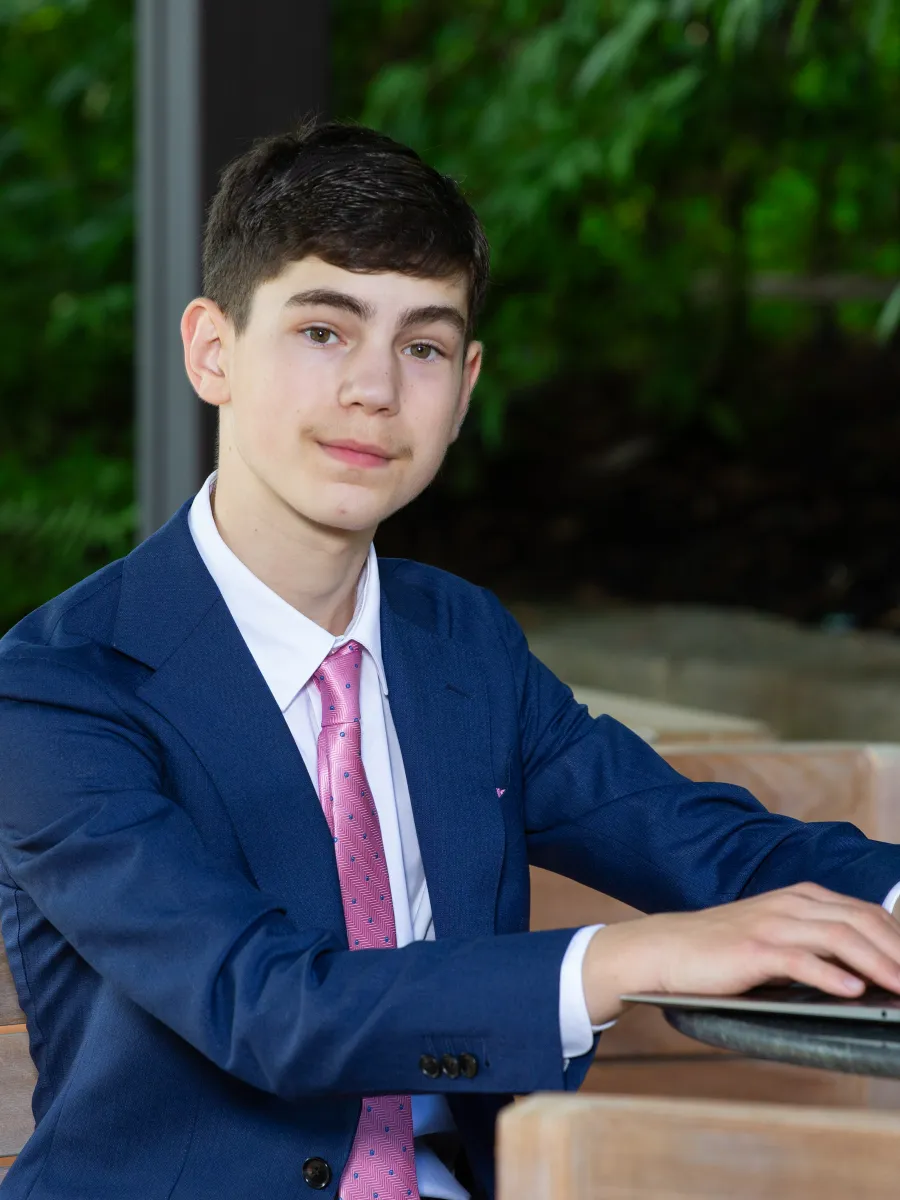 Evan Uster working on a laptop at an outdoor table